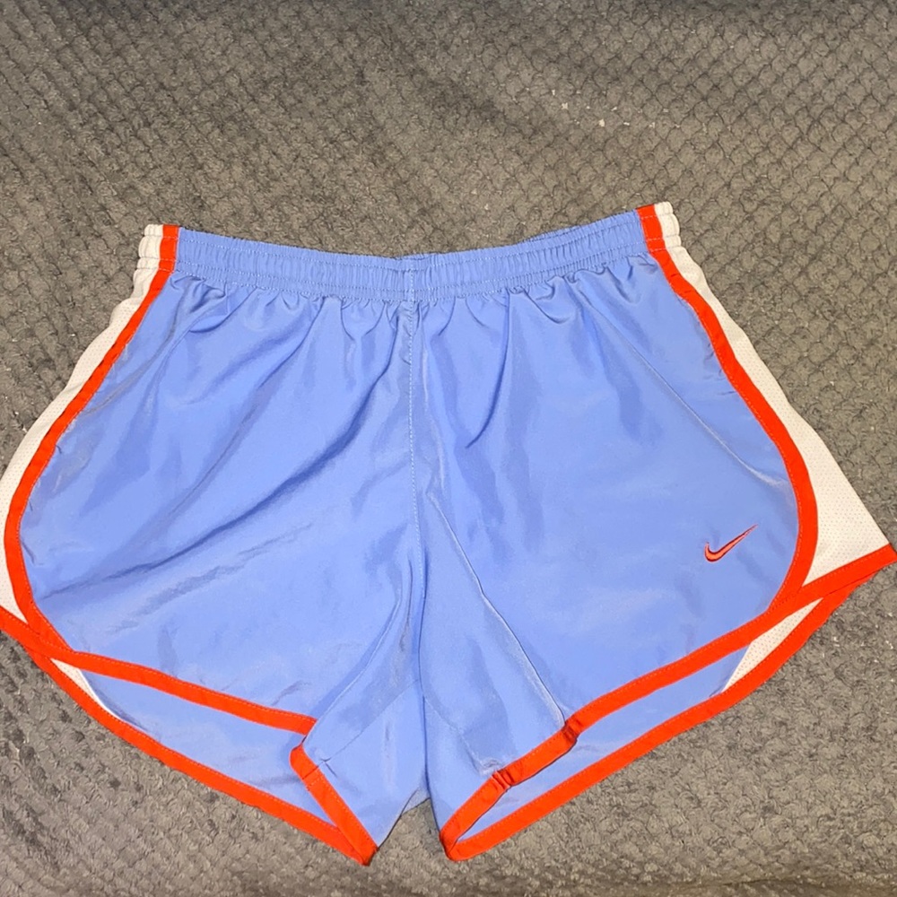 Kids Nike shorts. A purplish color with red lining